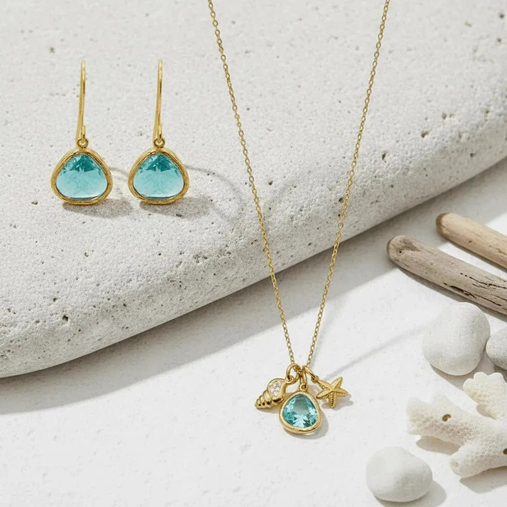Gold jewelry set with turquoise stones on a beach setting