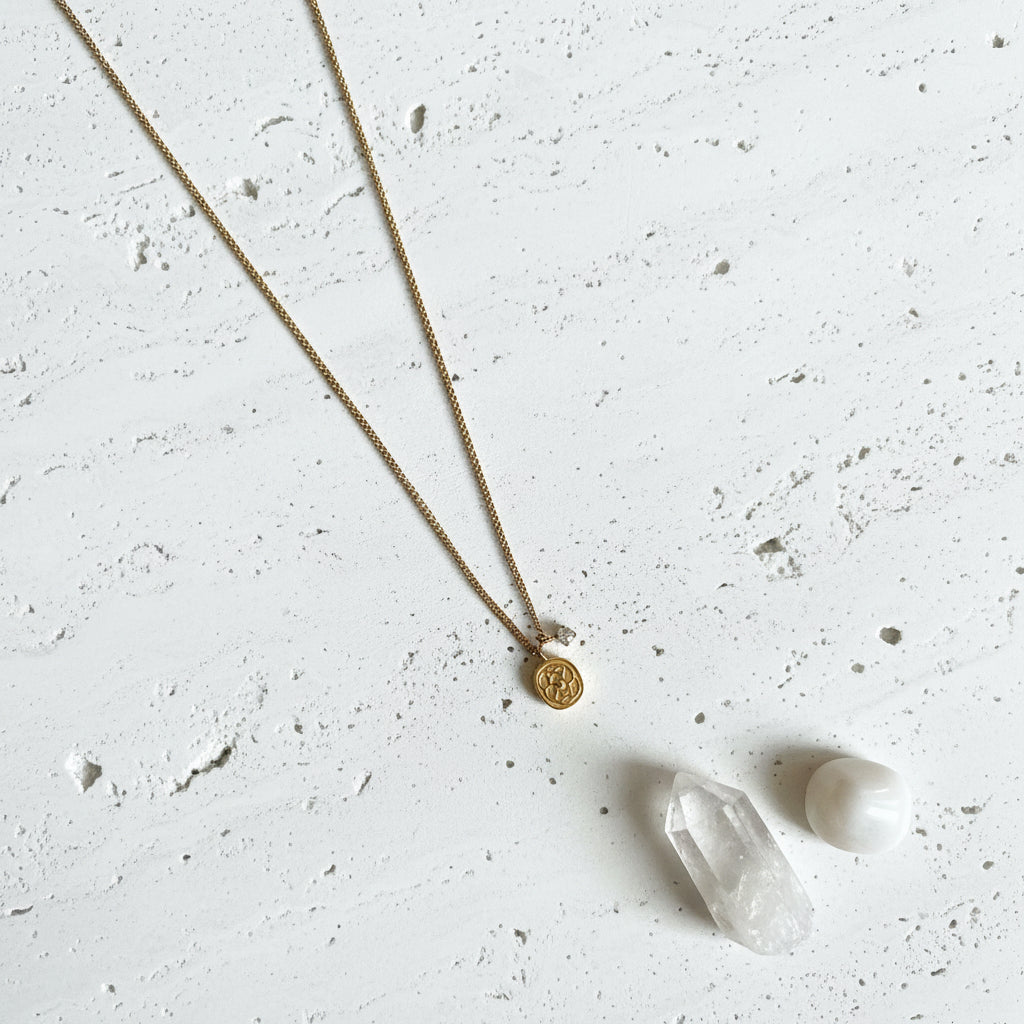 Gold floral medallion necklace with a mini cubic zirconia centre and a tiny CZ charm on a fine chain