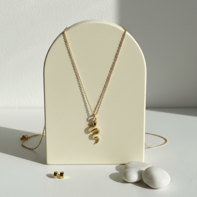Gold snake pendant necklace with a blue eye — spirit animal jewelry for transformation