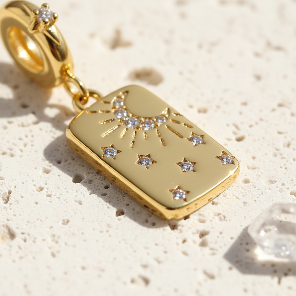 Close-up of a gold moon and star rectangular pendant with zircon star accents and a zircon-set bail