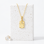 Gold-plated sterling silver rectangular pendant with a crescent moon, rays and zircon-set stars, hanging on a fine chain