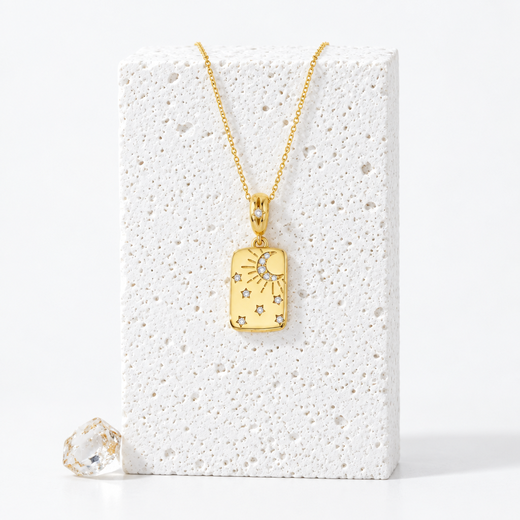 Gold-plated sterling silver rectangular pendant with a crescent moon, rays and zircon-set stars, hanging on a fine chain