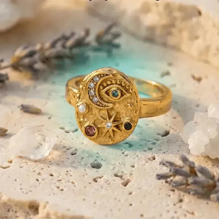 Gold ring with celestial design on a textured surface with text 'Celestial Moon Ring' and 'SHOP NOW' button.