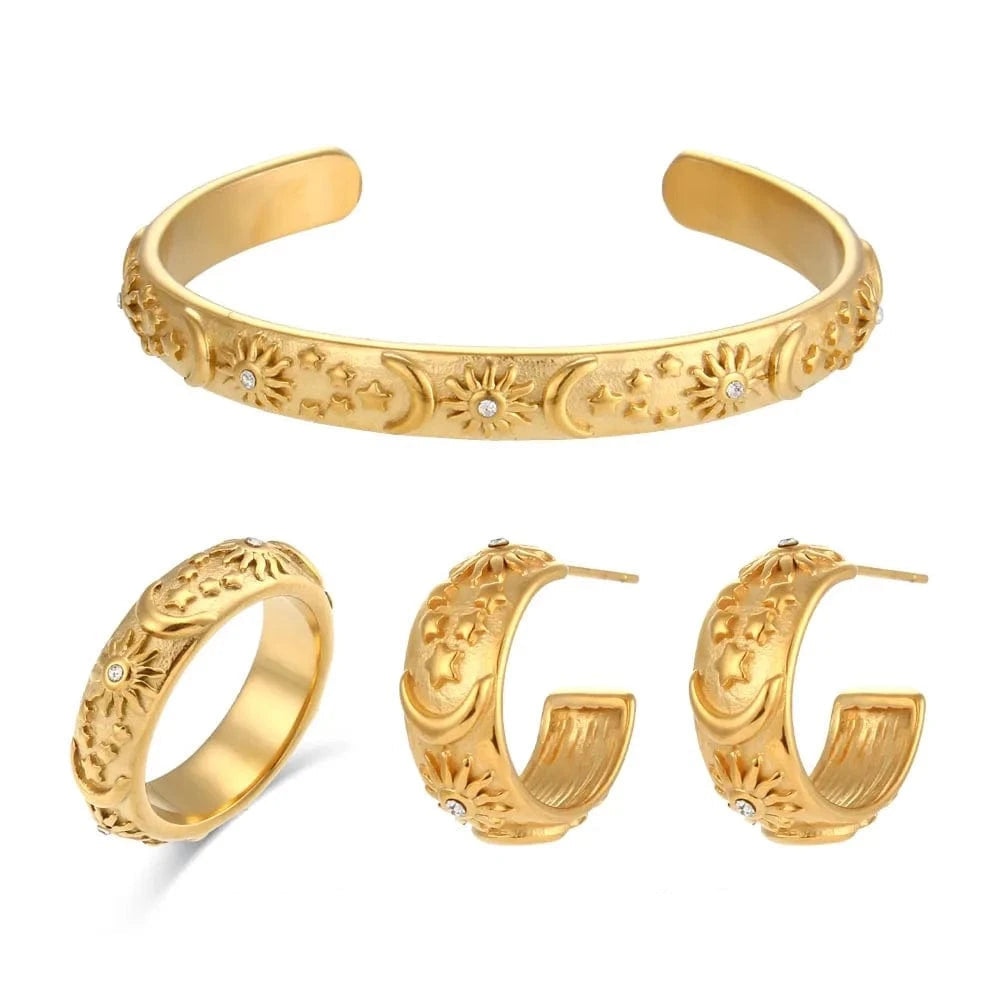 Gold jewelry set including a bracelet and earrings on a white background 