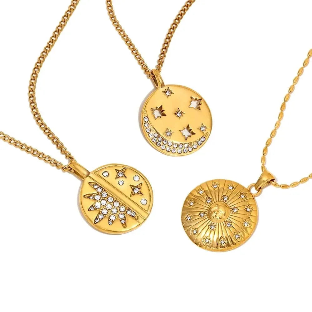 Three gold necklaces with star and moon designs on a white background'.