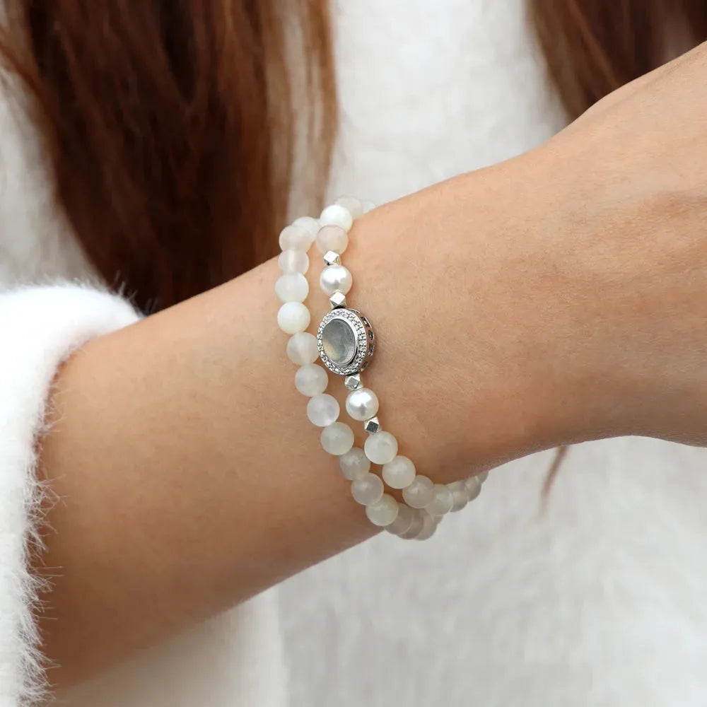 moonstone Pearl bracelet with a silver clasp on a wrist against a neutral background