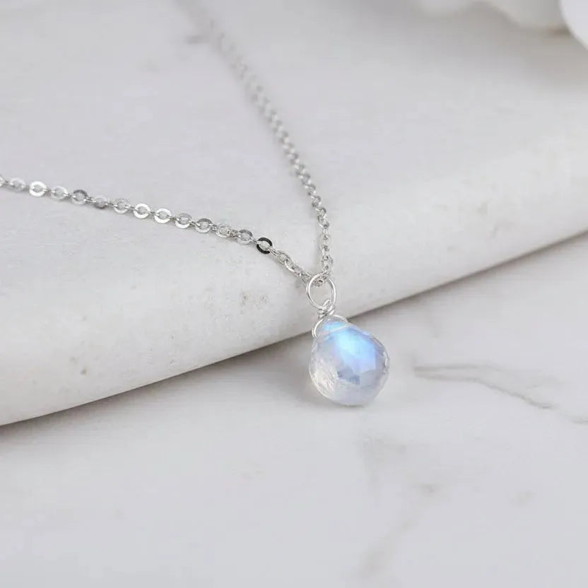 Moonstone Crown Chakra pendant necklace on dark background for intuitive, mystical energy