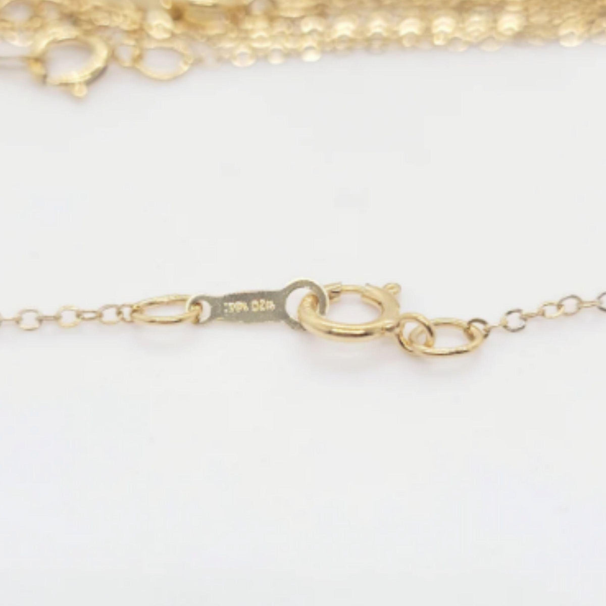 Close up of gold filled cable chain clasp and spring ring detail