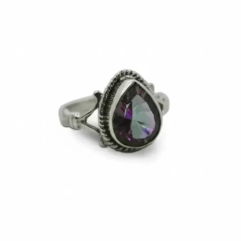 Silver ring with a purple teardrop-shaped gemstone on a white background