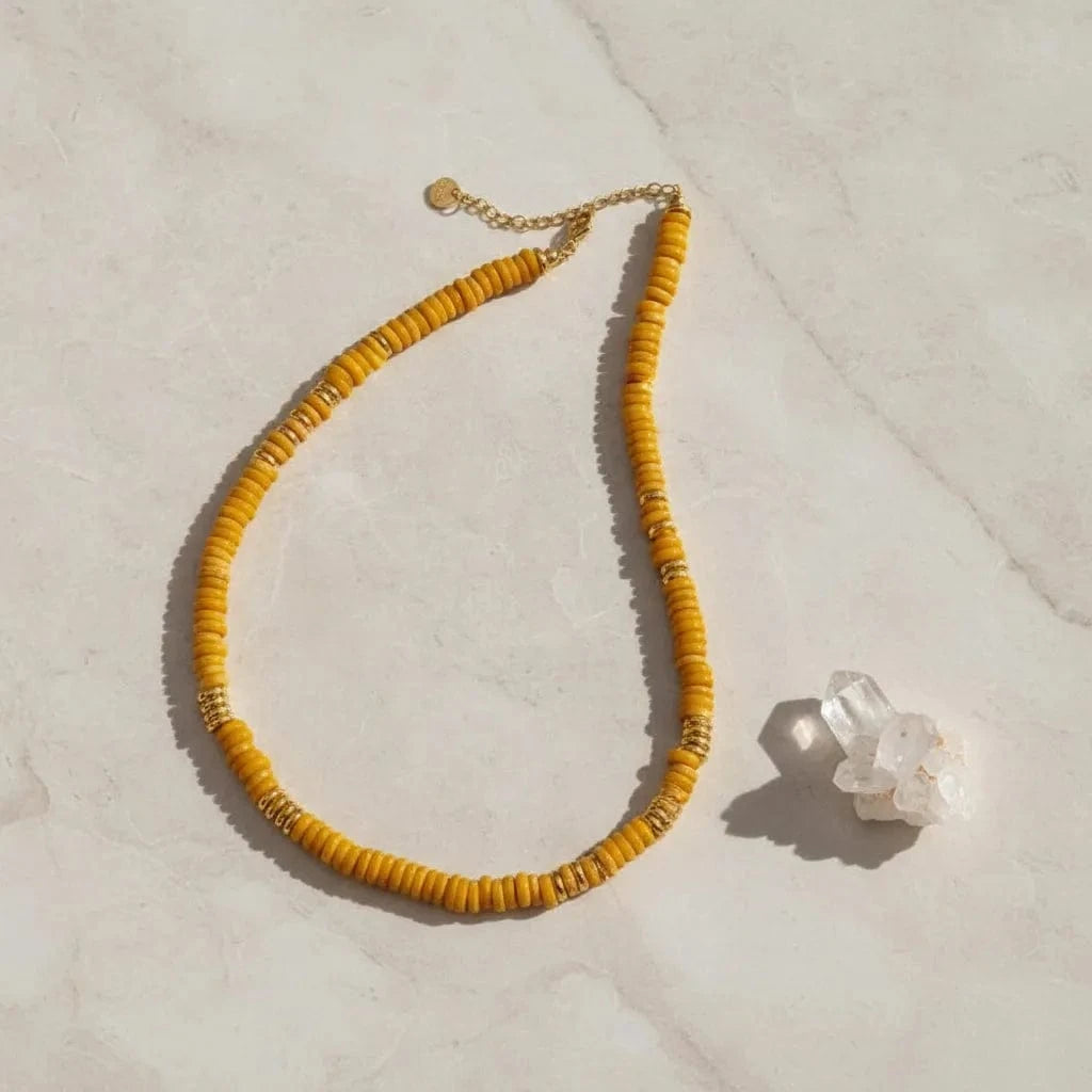 Yellow beaded necklace on a white background