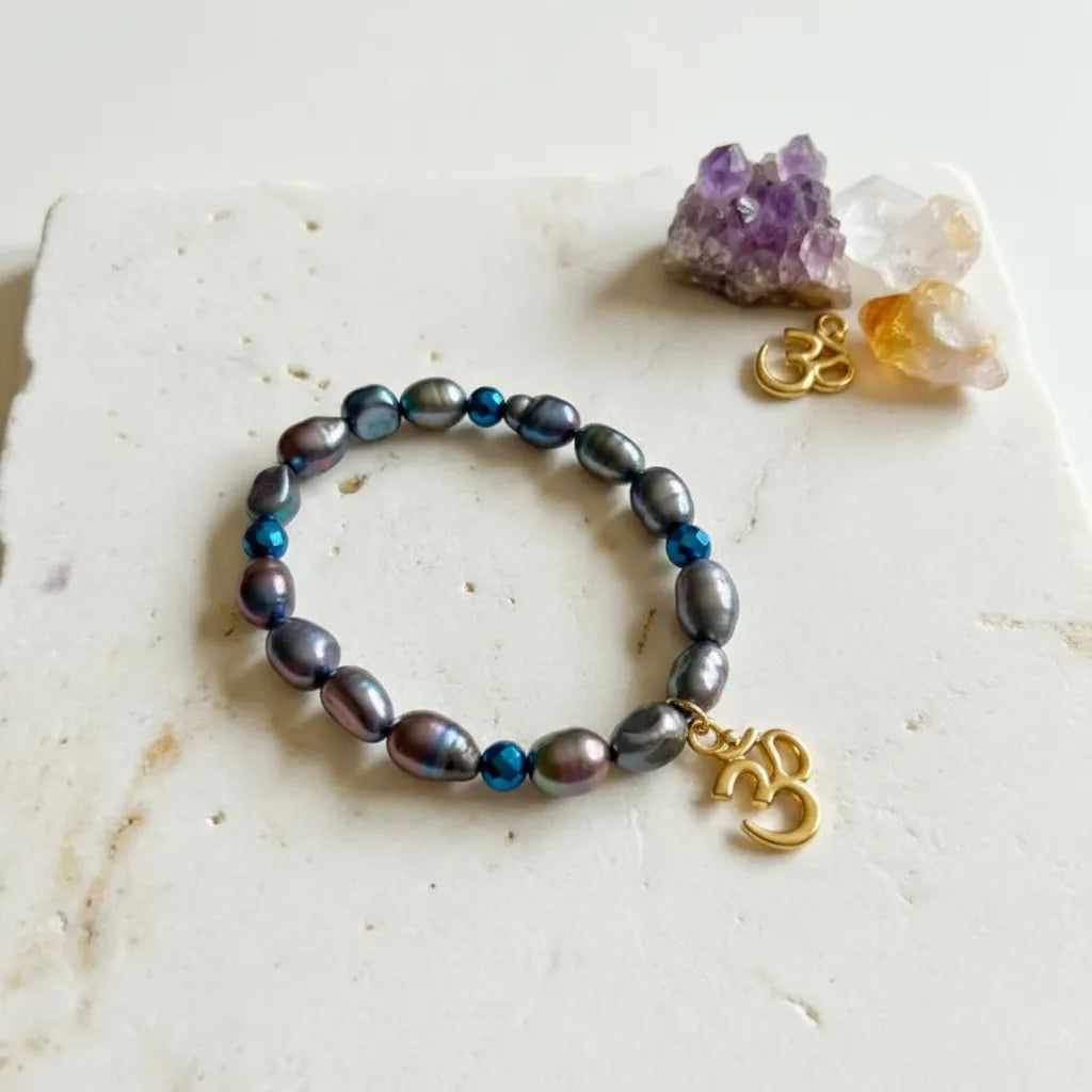 Om & Peacock Pearl elastic bracelet with gold om charm, one-of-a-kind