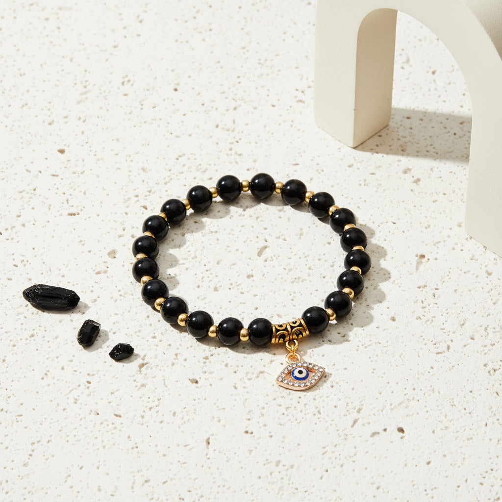 Black onyx evil eye stretch bracelet on natural stone beads — symbol jewellery for grounding and protection
