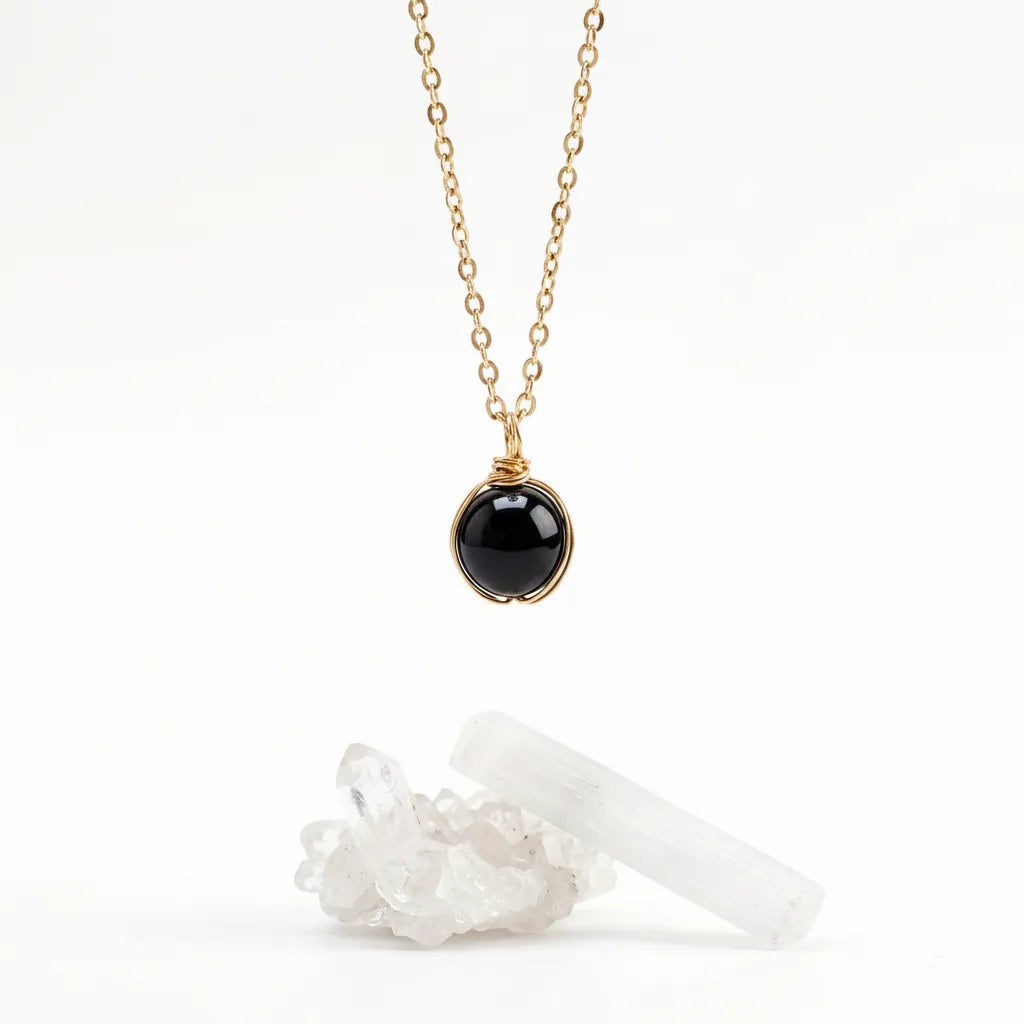 Necklace with a black onyc pendant on a white background