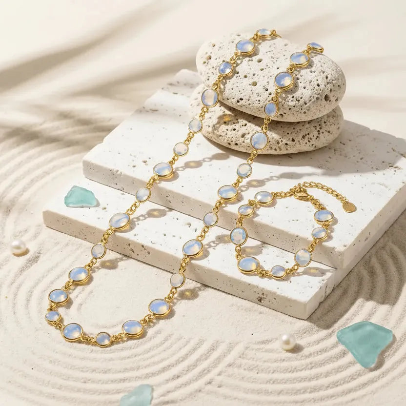 Gold necklace with opal stones on a stone surface