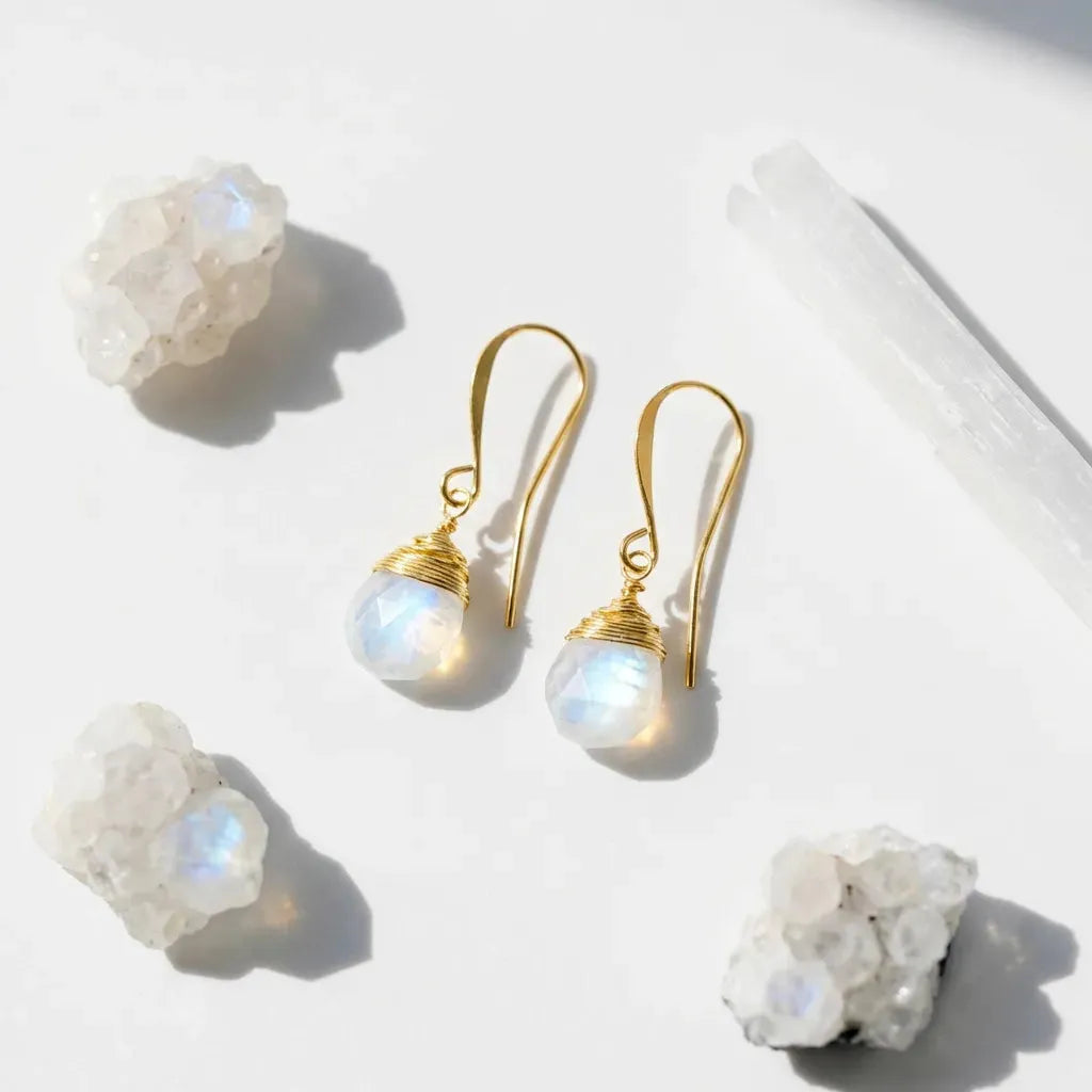 opalite gold earrings with moonstone beads on a light background