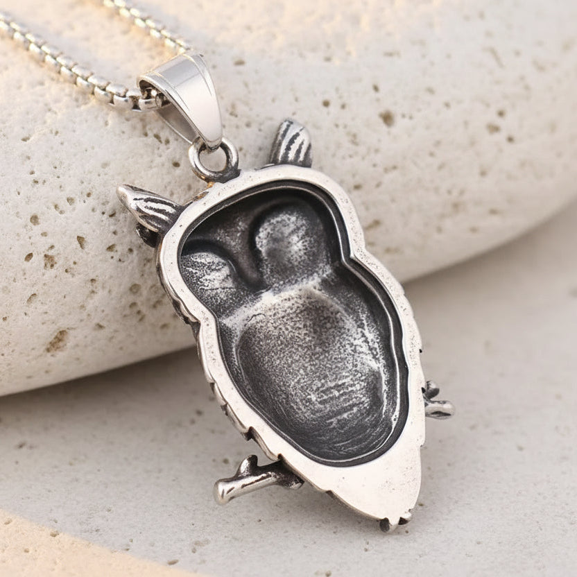 Silver owl pendant on a brown leather background