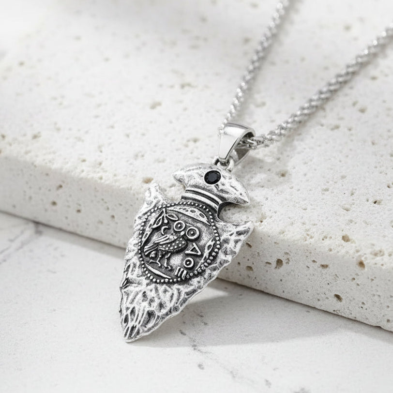 Silver pendant on a chain against a white background