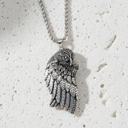 Silver owl pendant necklace on a white background