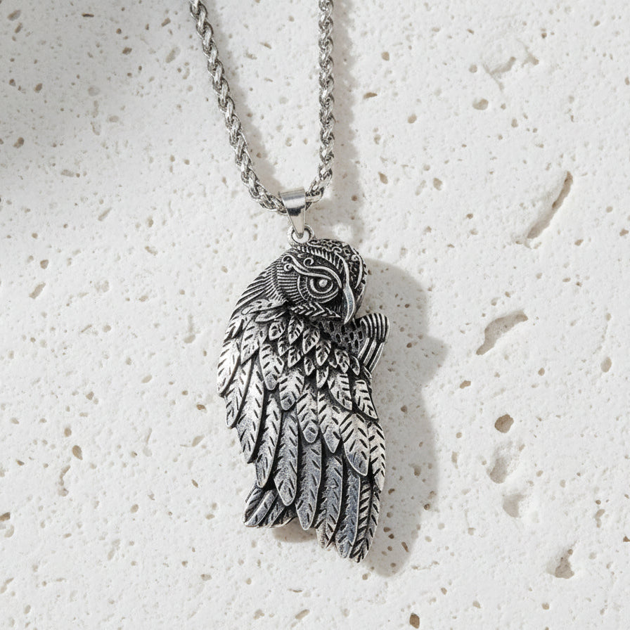 Silver owl pendant necklace on a white background