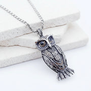 Decorative silver fish pendant with intricate details on a white background