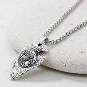 Silver owl pendant on a chain on white background