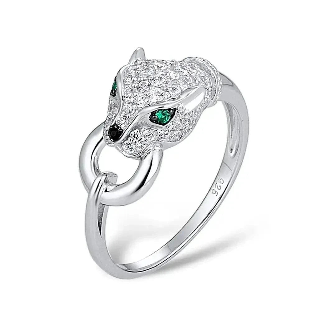 Silver panther head ring with green eyes on a white background,