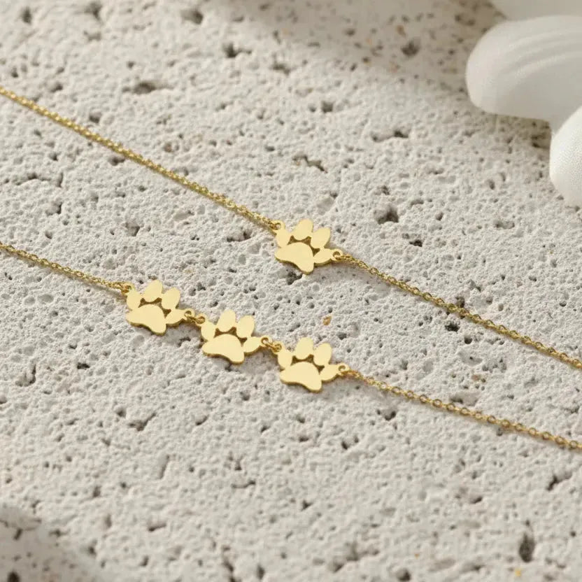 Gold paw print pet name bracelets — keepsake necklace for love and rescue