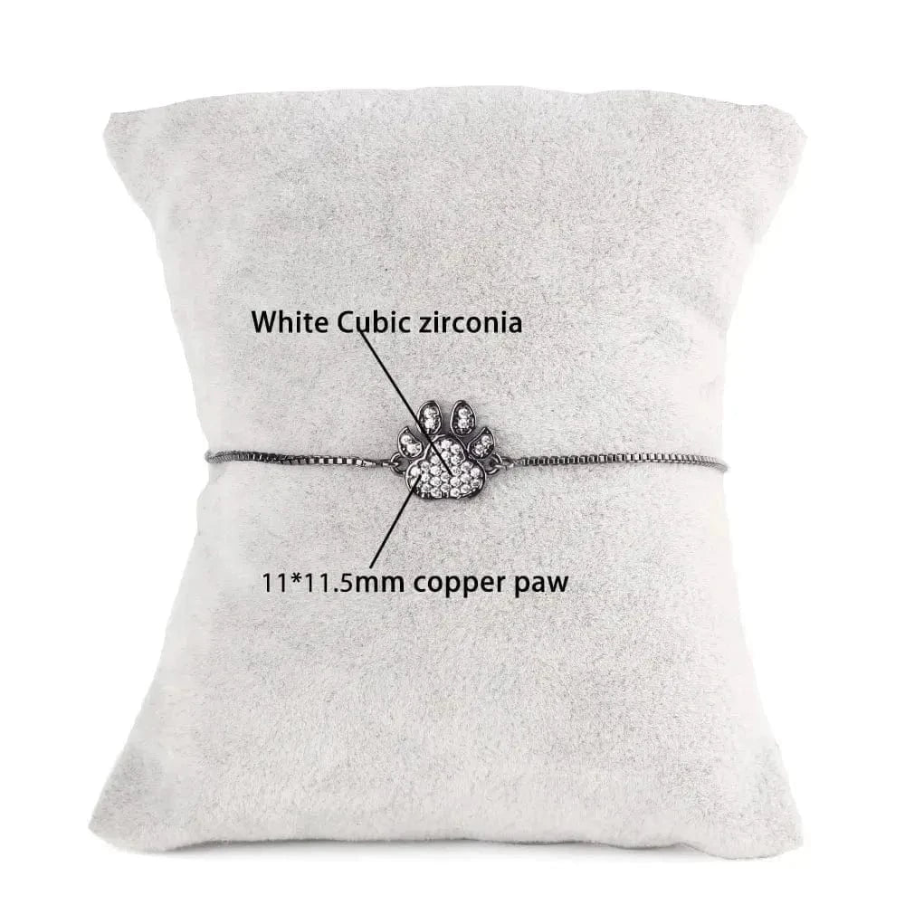 Bracelet with paw charm on a gray cushion, labeled with gemstone and paw measurements.