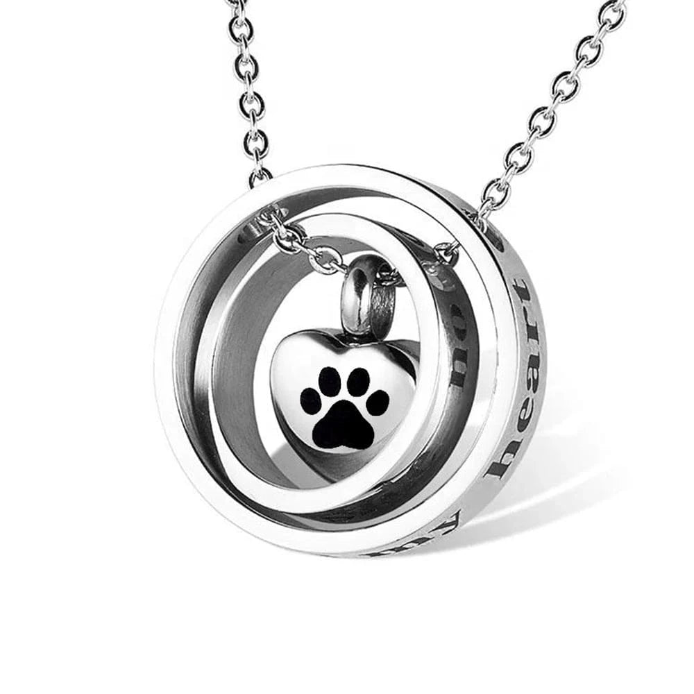 Silver necklace with a heart-shaped pendant featuring a paw print on a white background