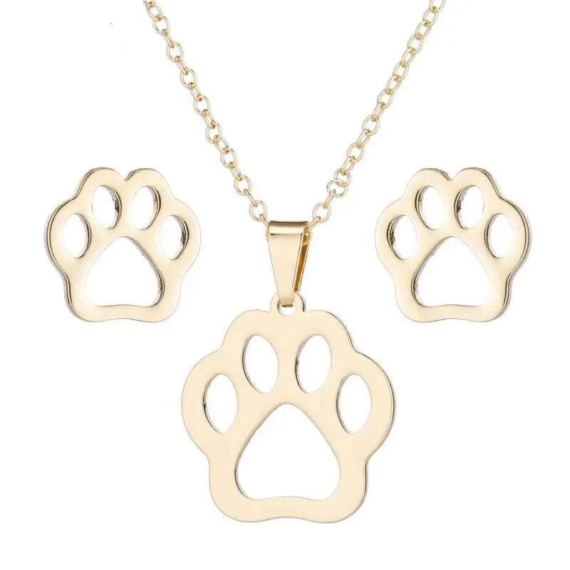 Gold paw print necklace and earrings set on a white background with 'SMJEL' branding.