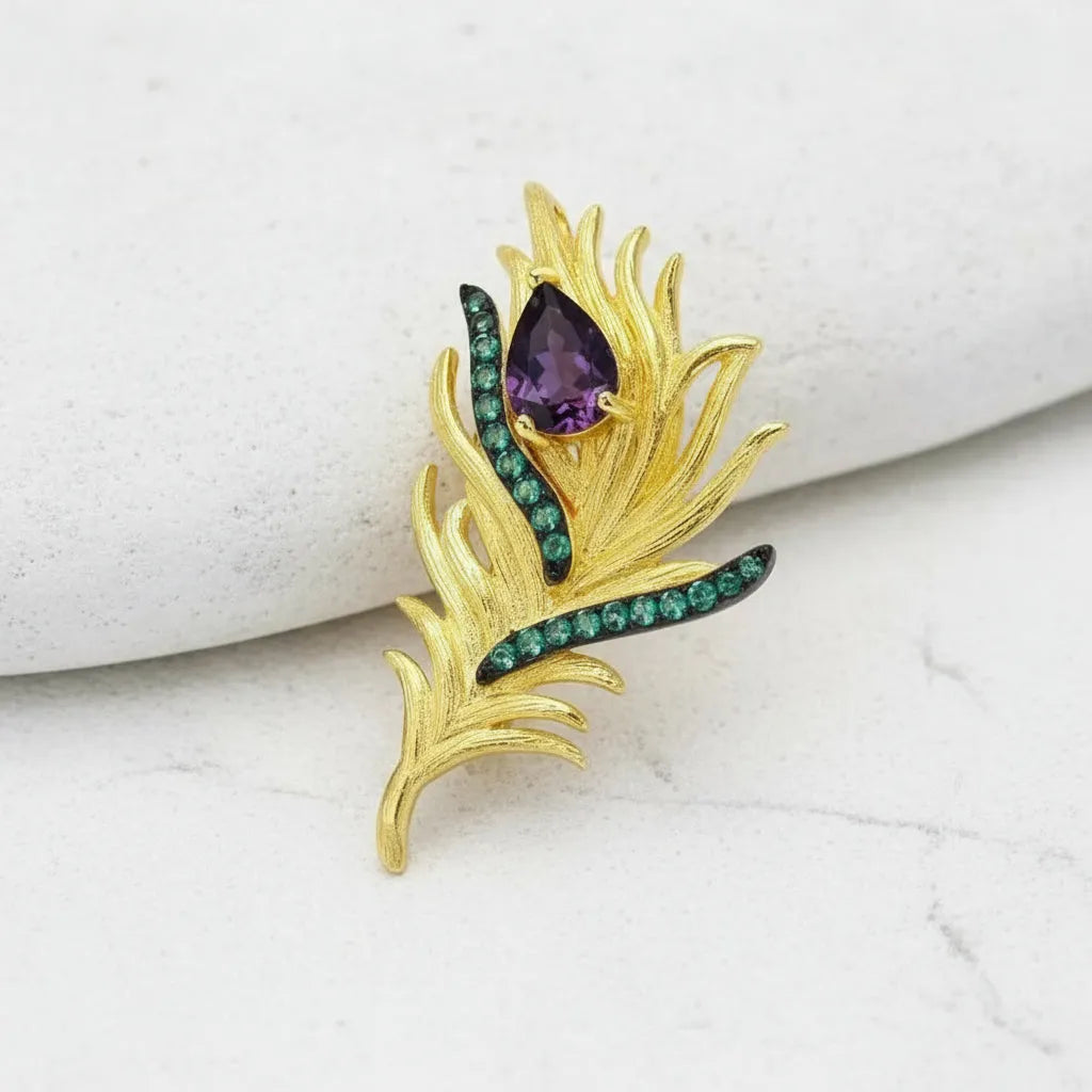 Peacock feather brooch and pendant in gold with purple amethyst and green gemstones