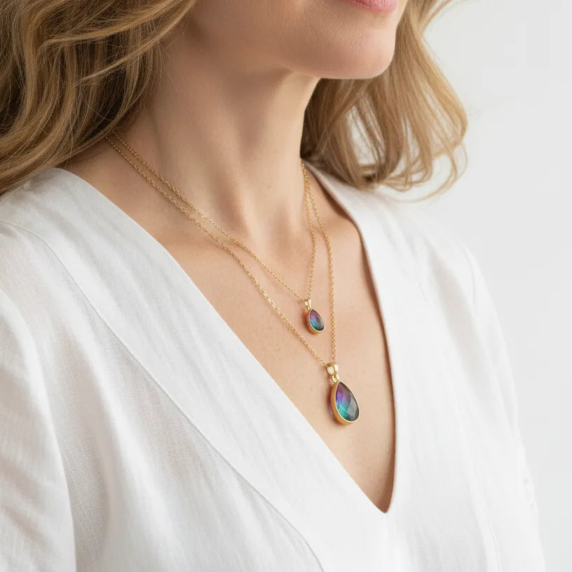 Peacock aura plumeria drop necklaces in gold with purple-green ombre stones