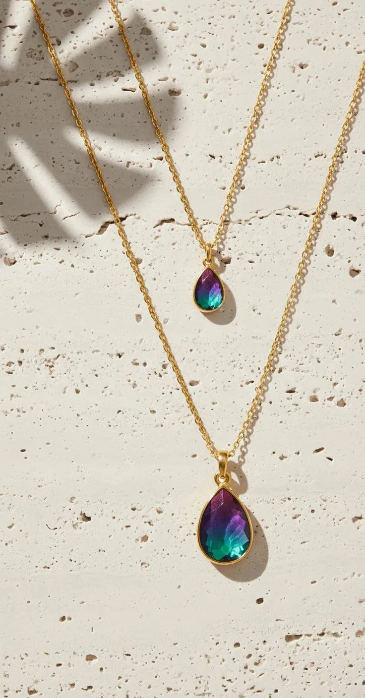 Necklace with two teardrop-shaped pendant charms on a white background