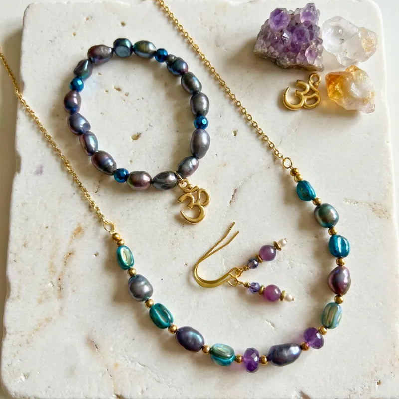 Om & Peacock Pearl one-of-a-kind set — necklace, bracelet, and amethyst drop earrings