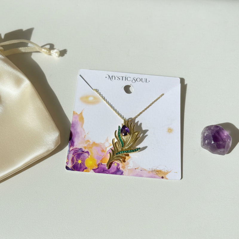 Gold peacock feather brooch and pendant with genuine amethyst on a Mystic Soul Jewelry card