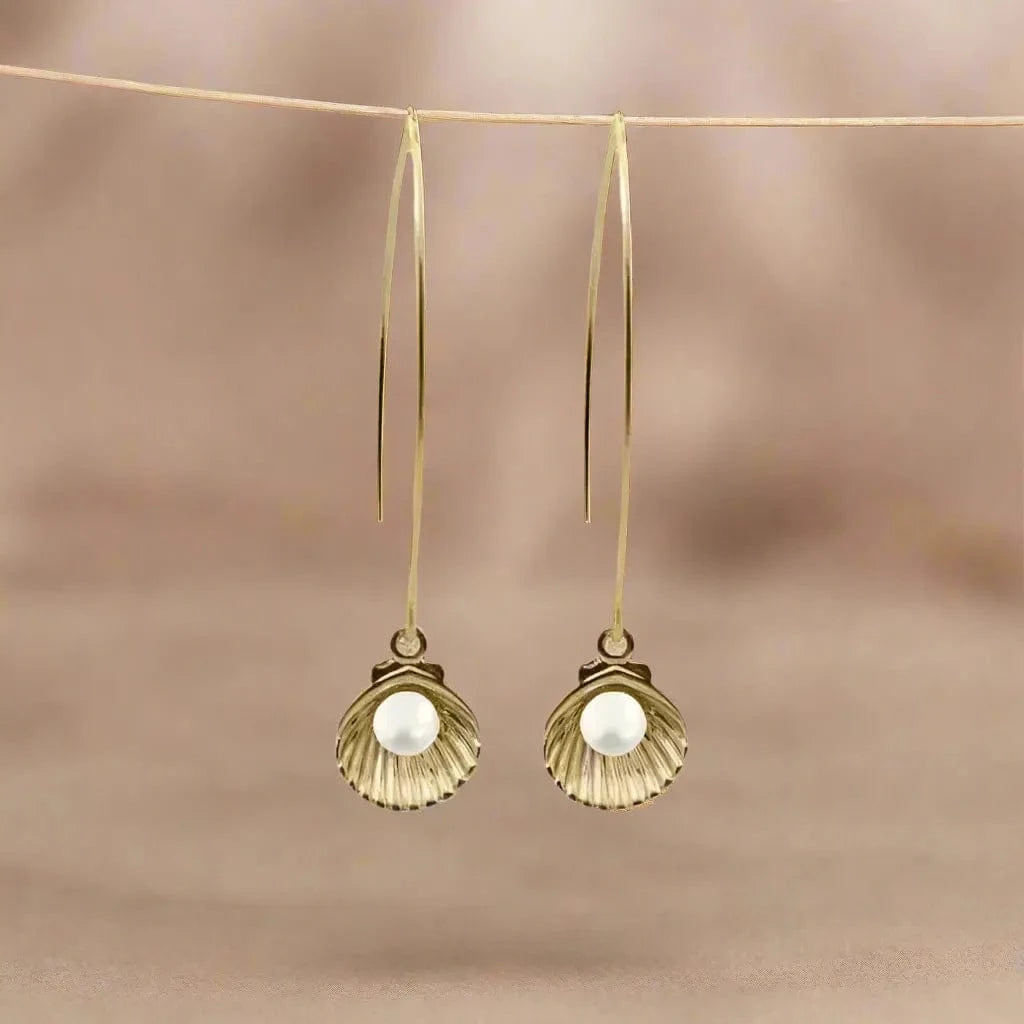 Long gold pearl in shell earrings