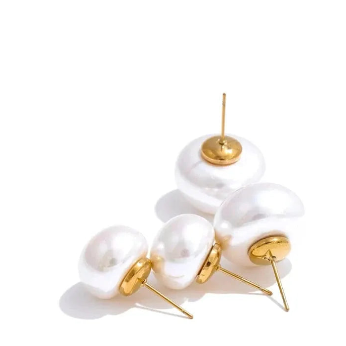 Pearl earrings with gold accents on a white background