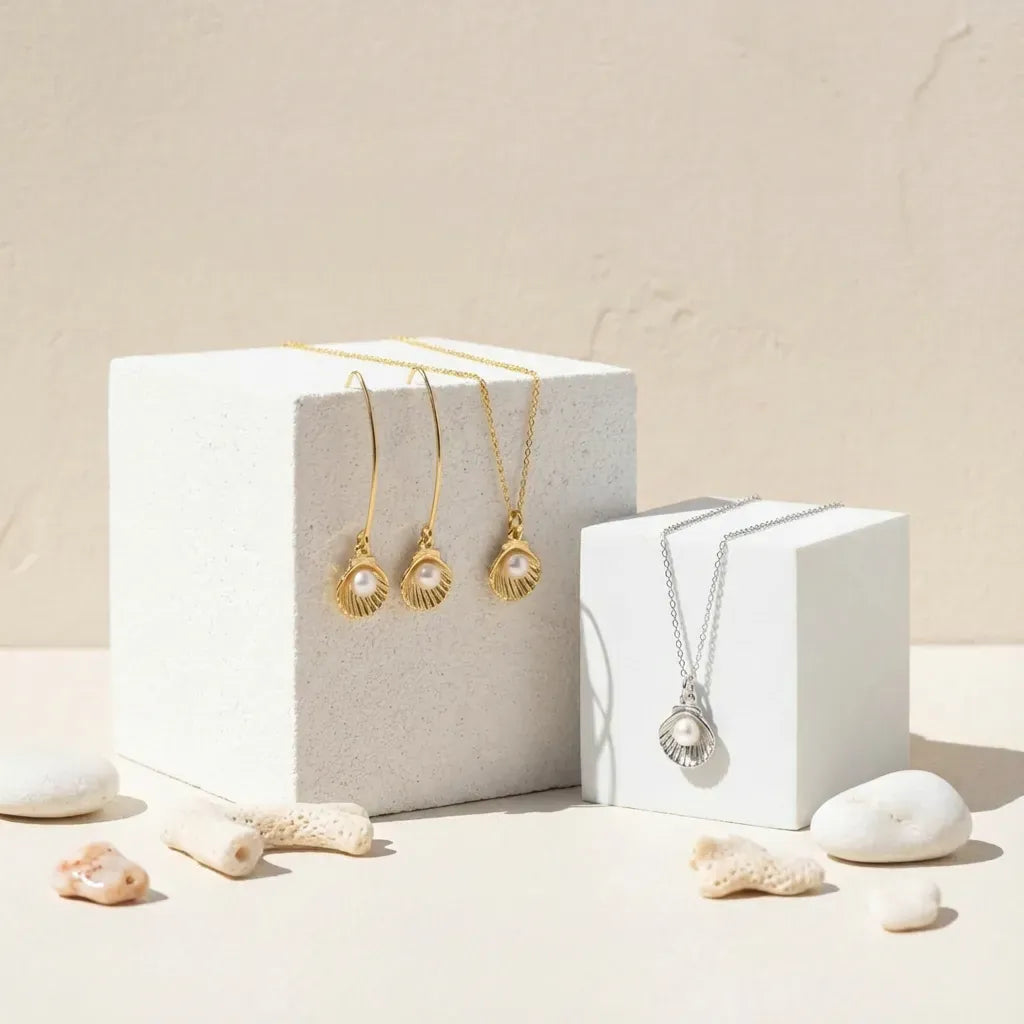 Two necklaces on white cubes with a beige background