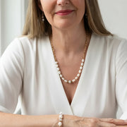 woman wearing potato pearl necklace and labradorite pyrite bracelet — one-of-a-kind crystal jewelry for calm
