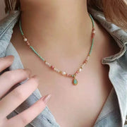 Woman wearing a freshwater pearl and gemstone beaded necklace — chakra jewelry for balance