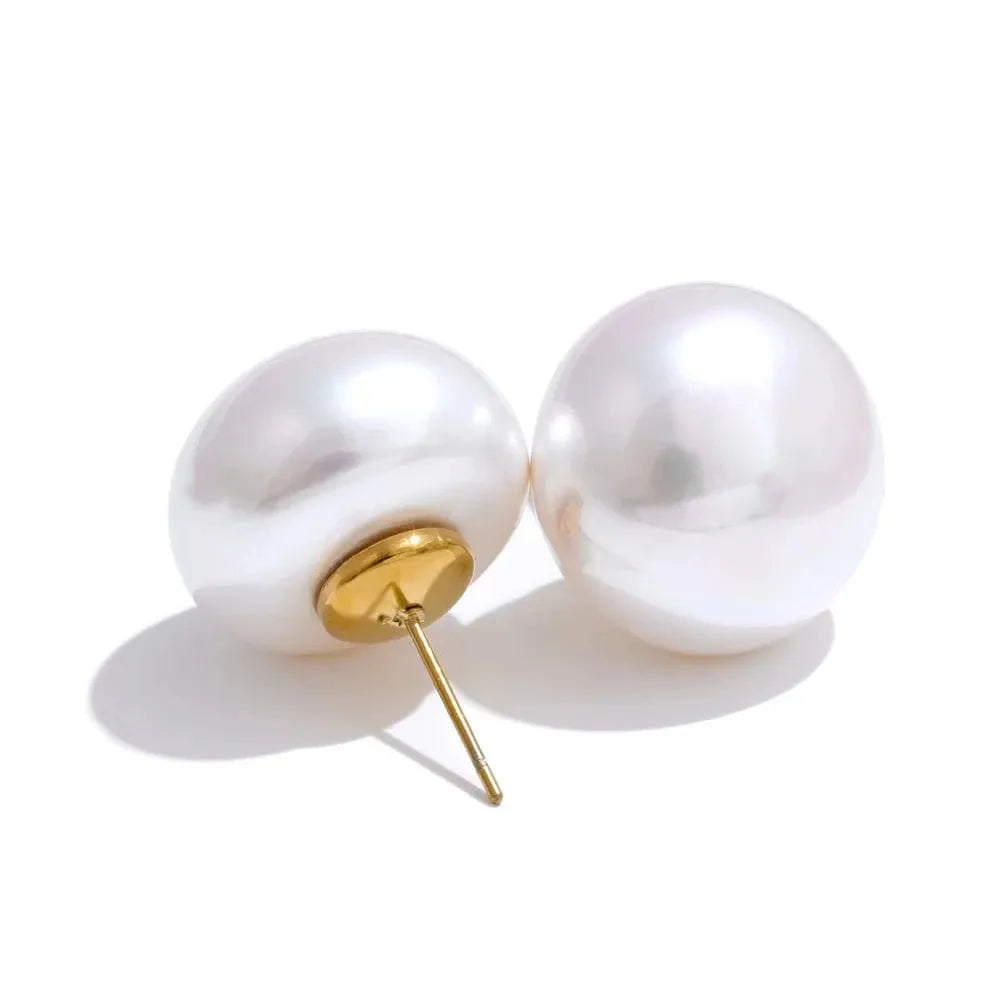Pearl earrings with gold posts on a white background