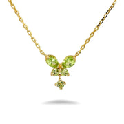 Gold necklace with green gemstones on a white background