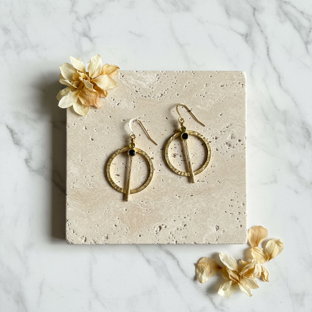 Hammered gold medallion earrings set with natural peridot — August birthstone jewelry