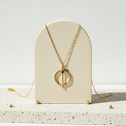 Hammered gold medallion necklace set with natural peridot — August birthstone jewelry