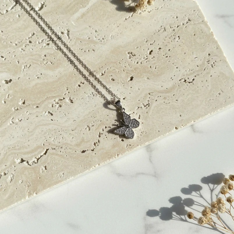 Close-up of the petite crystal butterfly pendant — spirit animal jewelry detail