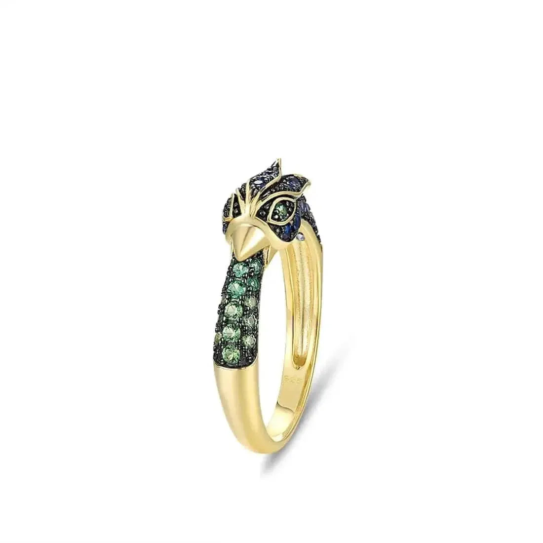 Gold ring with green gemstones on a white background