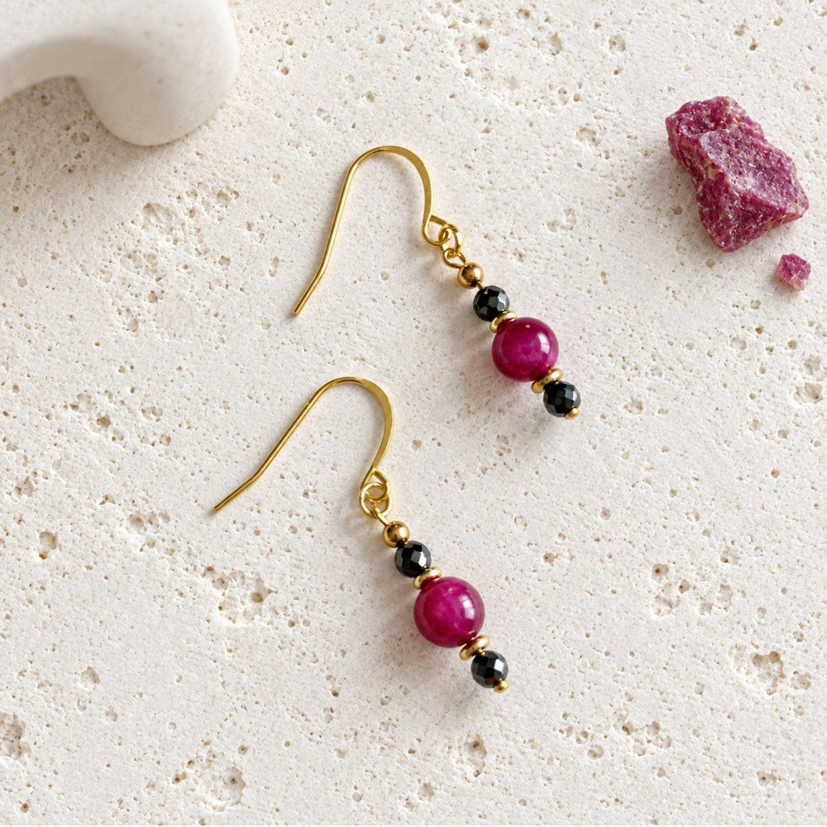 Pink tiger's eye drop earrings with faceted hematite beads above and below each smooth pink stone