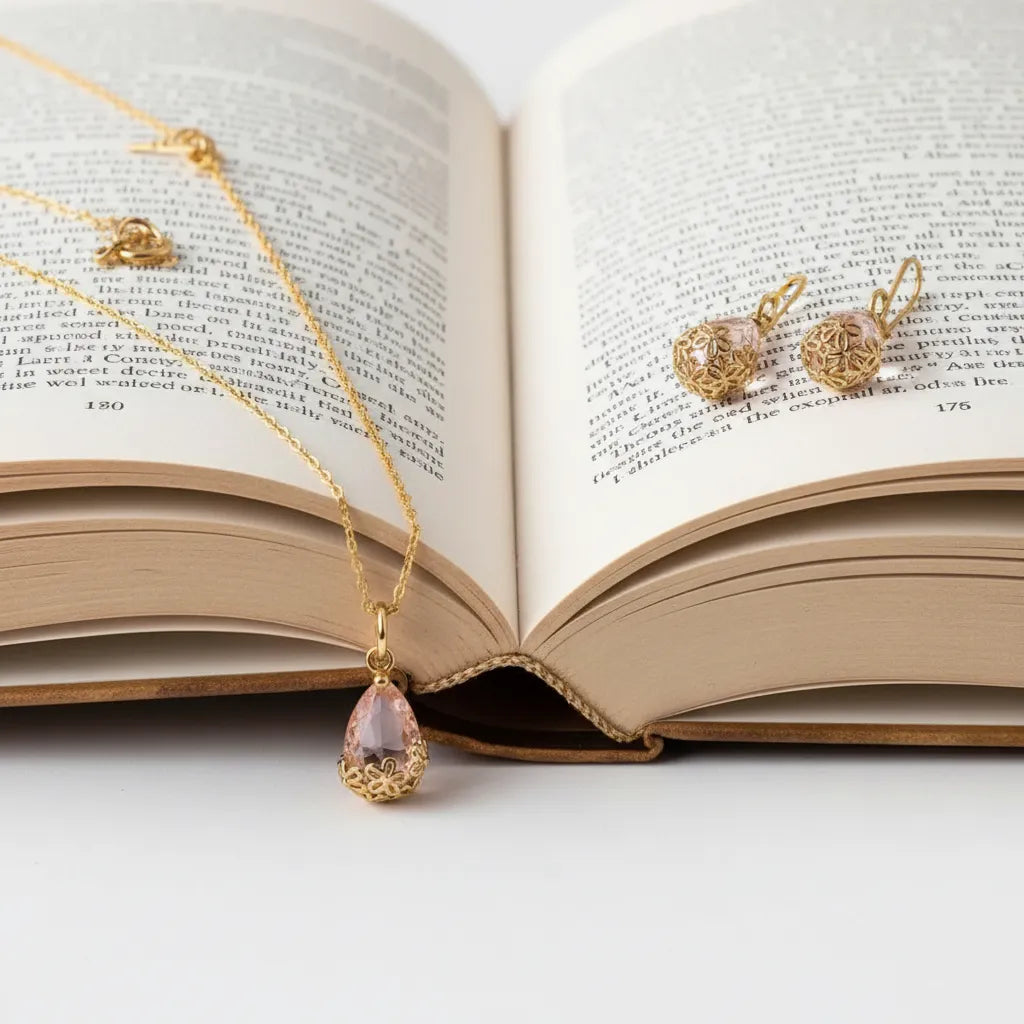 Gold jewelry including a necklace and earrings on an open book