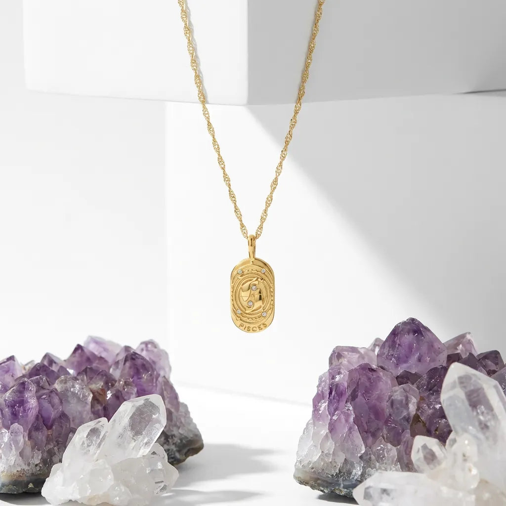 Gold necklace with a pendant on a white background with crystals.