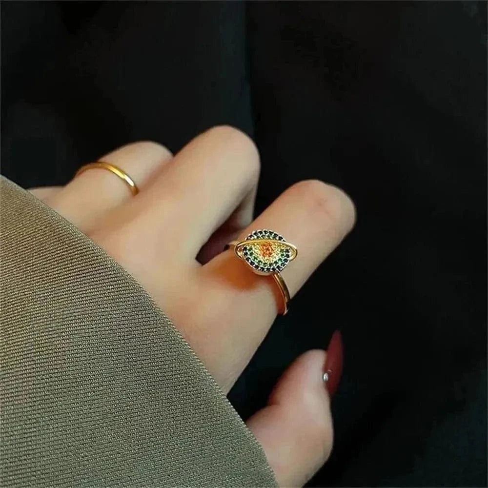 Close-up of a hand wearing two rings with a dark background